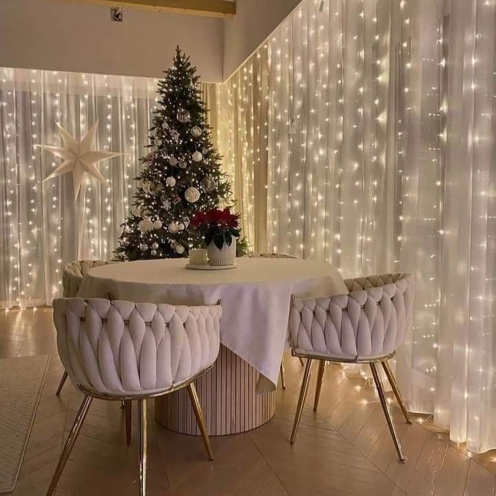 Dining room with Christmas tree and string lights on walls